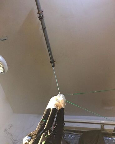 ceiling mounted rail setup for lowering robot onto work area suspended from ceiling